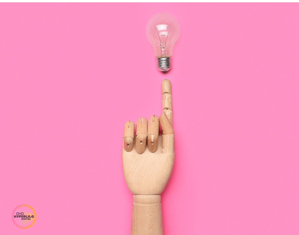 robot hand with a bulb at the finger tips and pink background