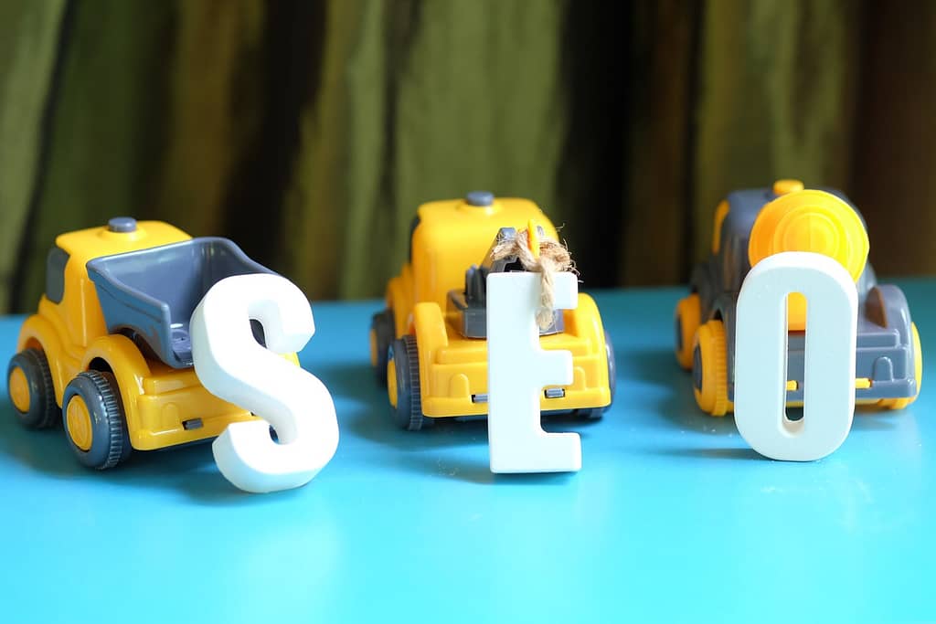 Toy trucks arranging the letters SEO.