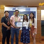 Four professionals posing with a certificate at a Negosyo Center certification event